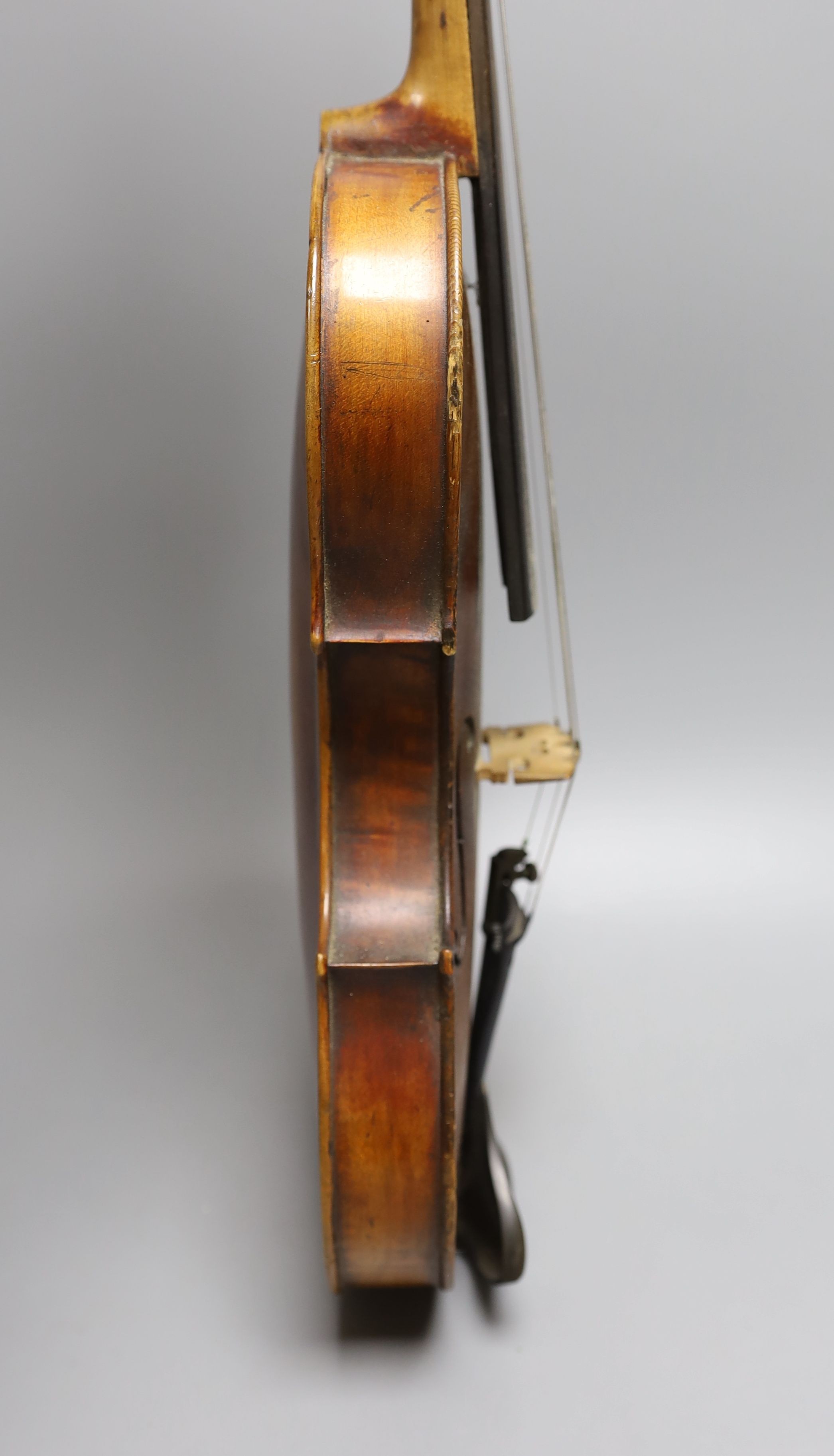 A 19th century violin with 14 inch 2 piece back, unlabelled, cased with silver mounted bow.